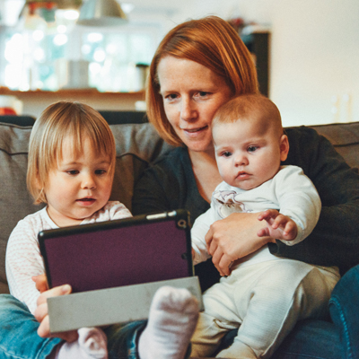 mum and children on an iPad